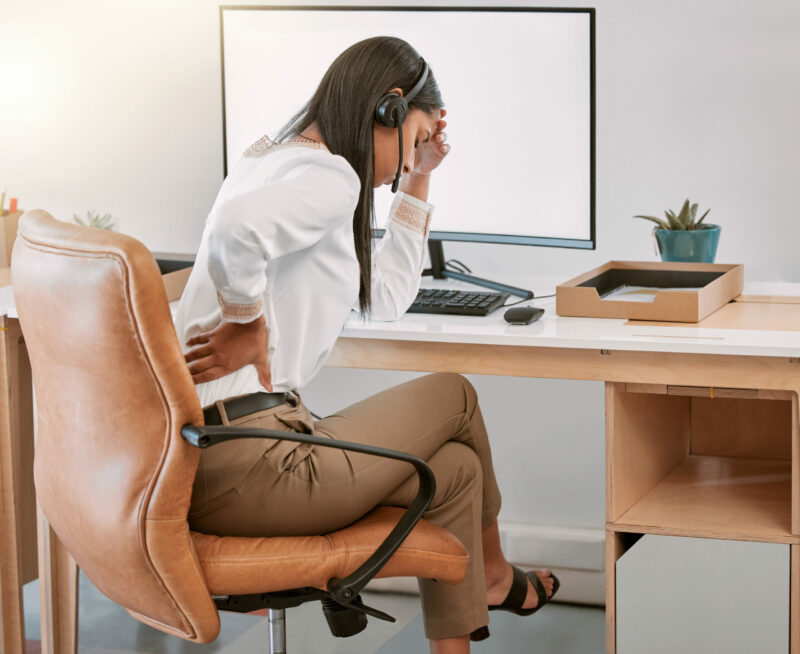 Woman, desk and back pain in office with muscle strain and hurt.